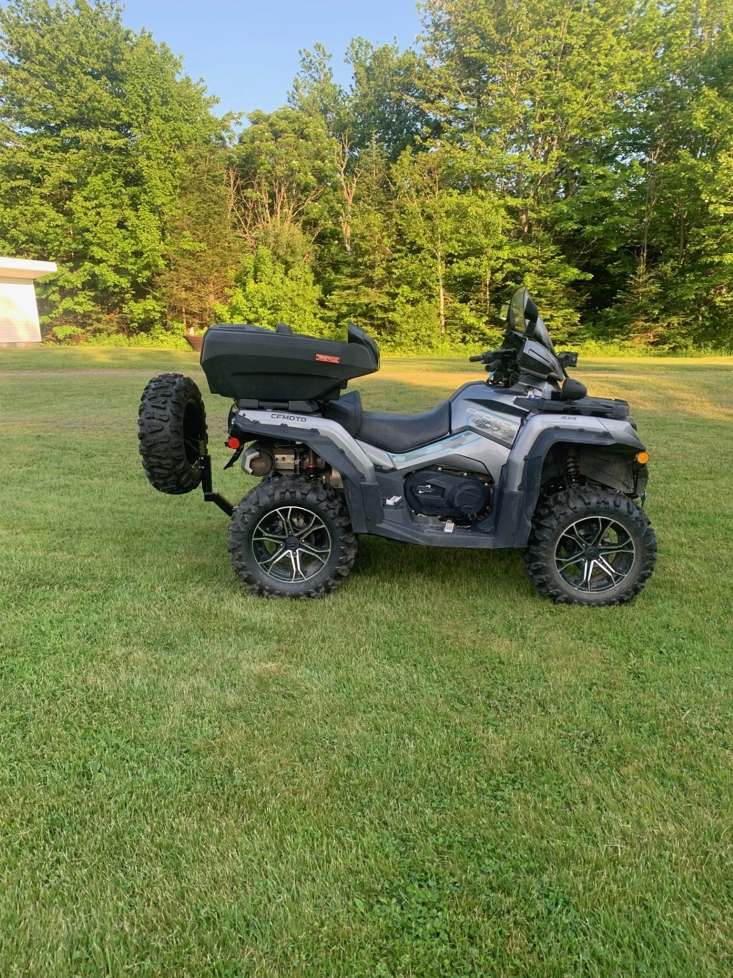 CFMOTO ATV with a spare tire carried on the Tire Backpack hitch mount