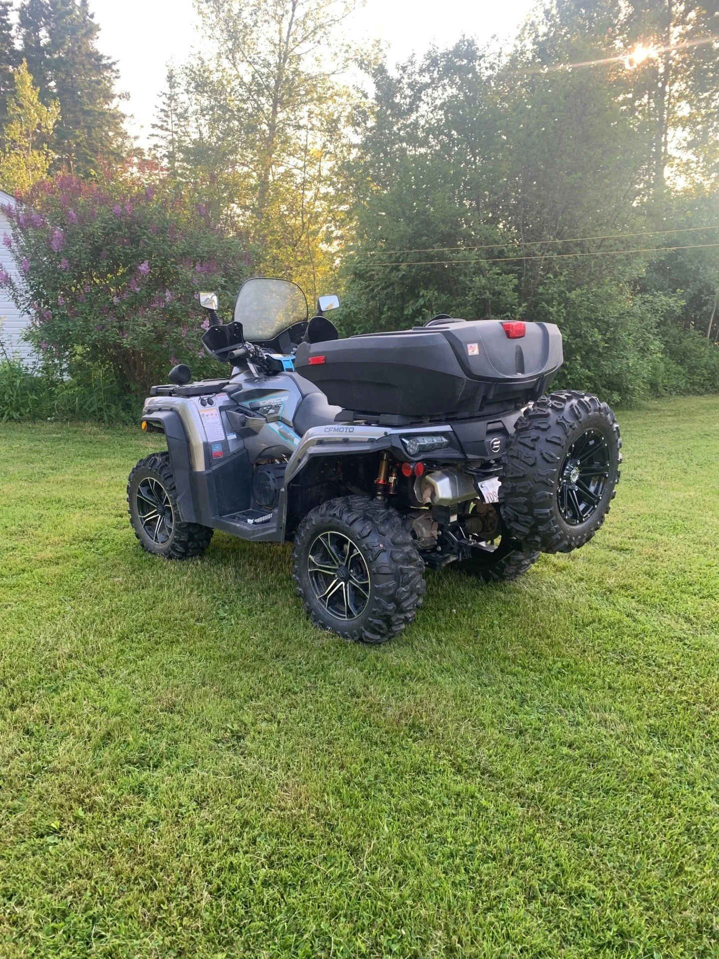 Rear view of an ATV with the Tire Backpack holding a full-size spare